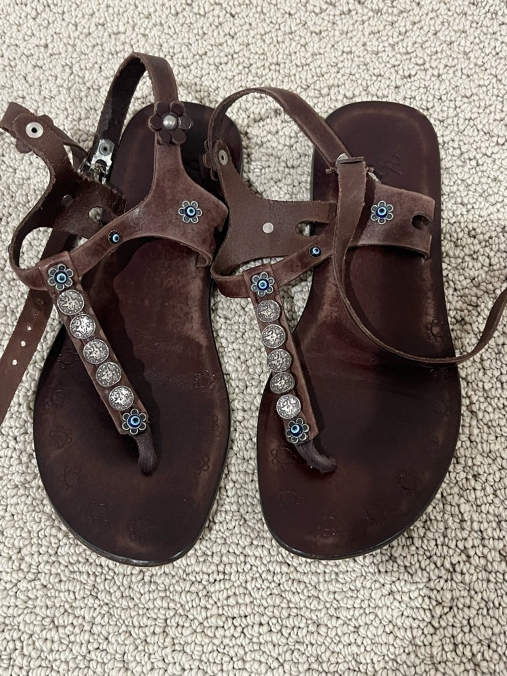 Women’s Brown Embellished T-Strap Sandals with evil eyes.